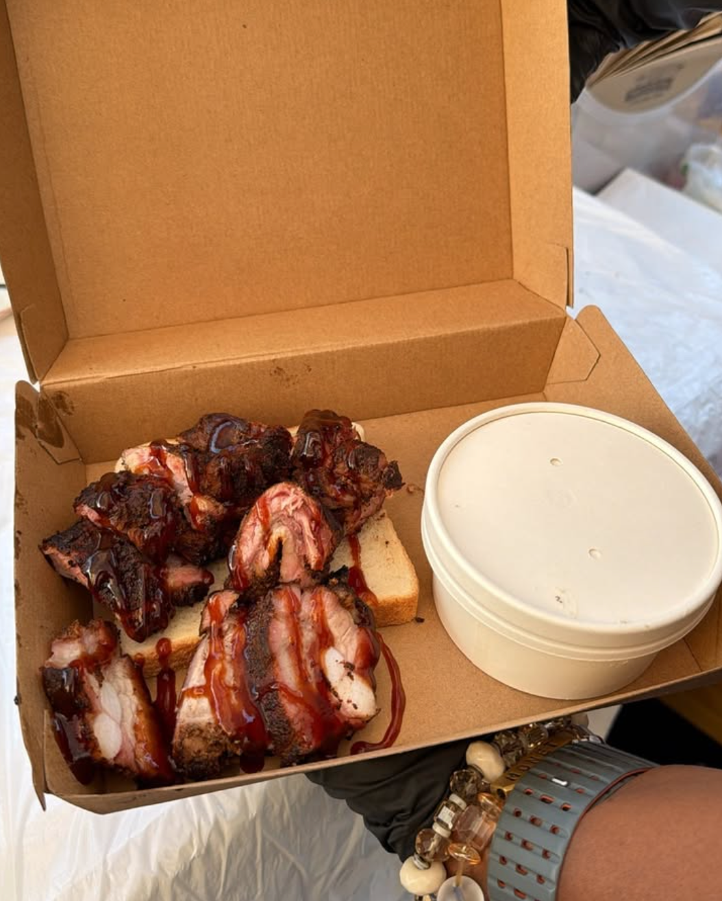 Smoked rib tips with sauce in a take-out box